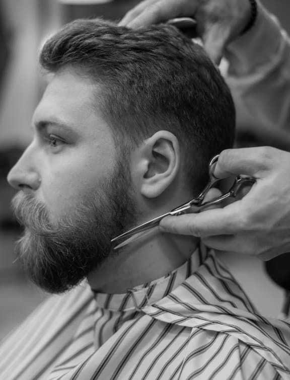 Barber running clippers through a zero fade