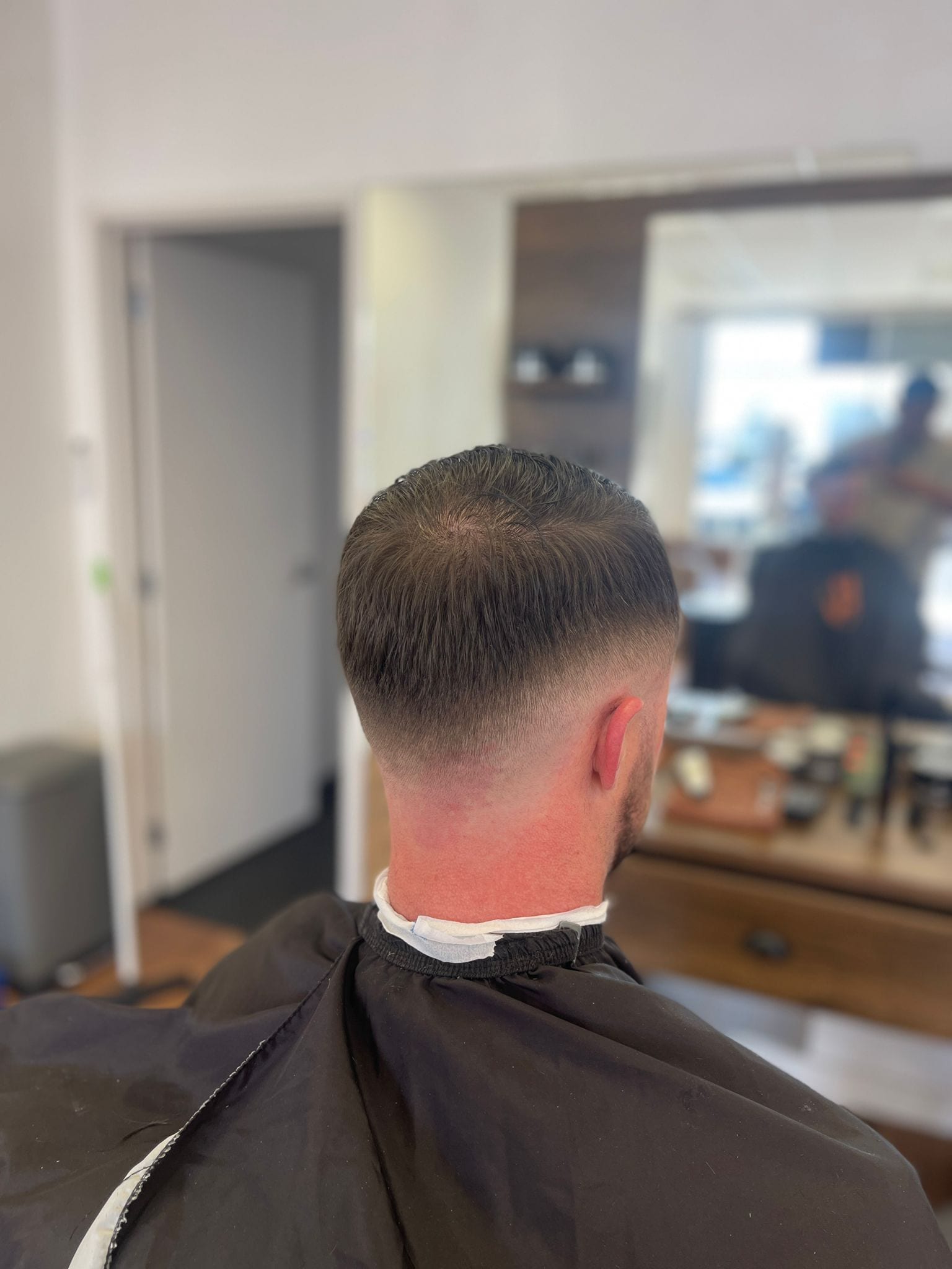 Tapered neckline and burst fade, viewed from behind